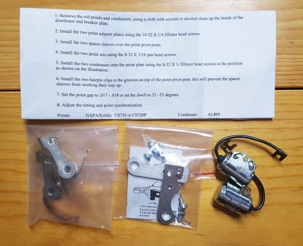 Instructions and motorcycle parts on a wooden surface. The parts are in small plastic bags. The instructions are a printed sheet.