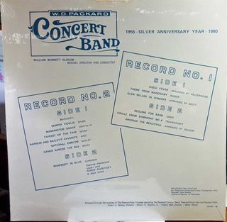 A white vinyl record album cover with blue text and a logo for the W.D. Packard Concert Band, featuring song listings for two records.
