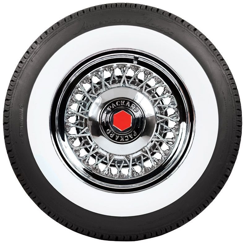 White wall tire with a Packard hubcap. The hubcap is chrome with a red Packard logo.