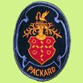 Oval Packard emblem with a red shield bearing white circles and a golden crest with a bird. 
