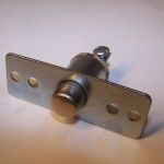 A metal pivot hinge with a rectangular mounting plate, and a cylindrical body with a rounded end, and a screw on top.