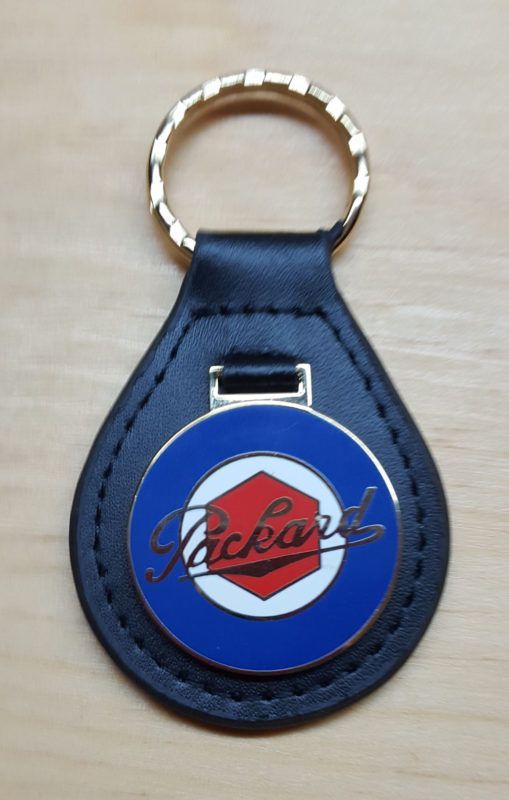 Black leather teardrop-shaped keychain with a gold ring. Features a blue and red Packard logo.