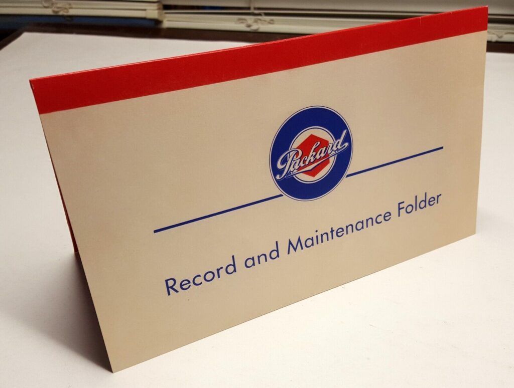Tan record folder with red trim and blue text. It has a logo and reads "Record and Maintenance Folder."