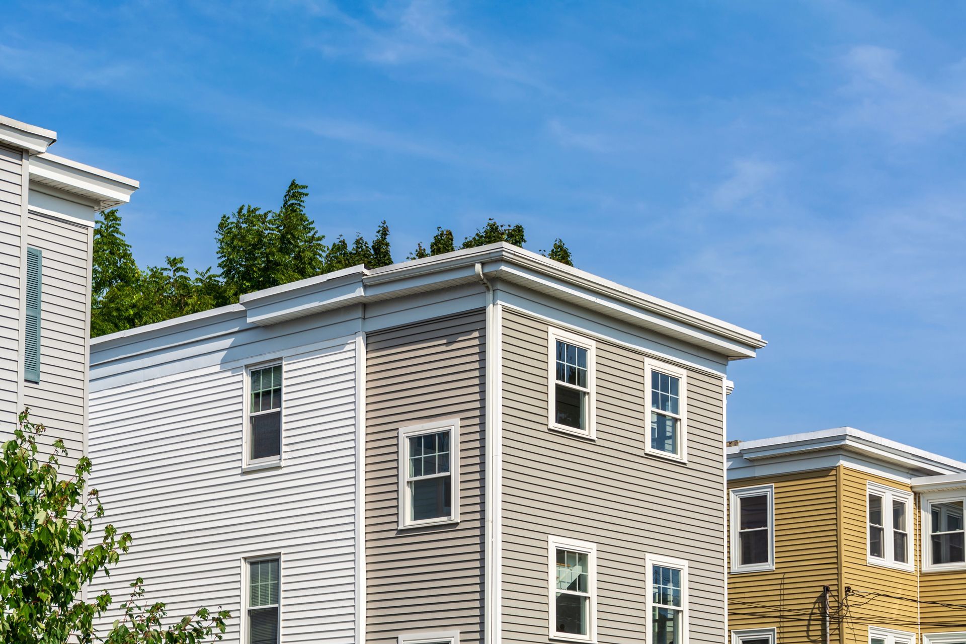 Row of Houses With a Blue Sky in the Background