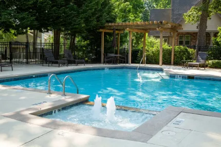 A large swimming pool with a fountain in the middle of it