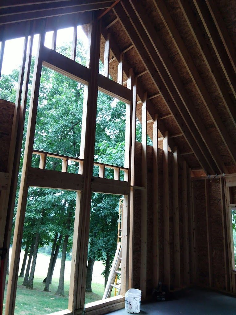 A room with a lot of windows and trees in the background