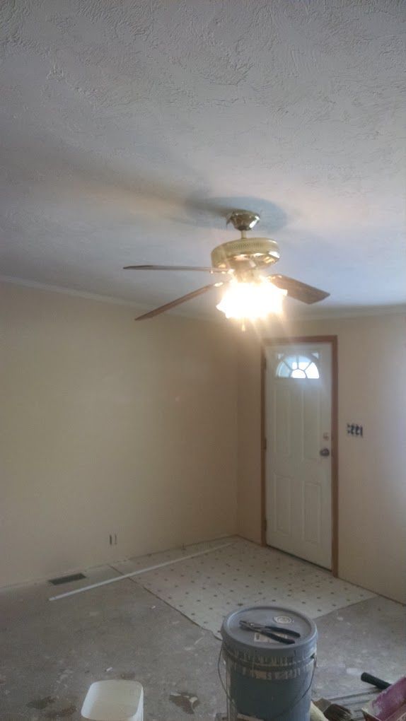 There is a ceiling fan in the corner of the room.