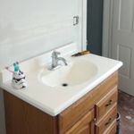 A bathroom sink with a storm trooper toothbrush holder