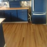 A kitchen with blue cabinets and a blue refrigerator