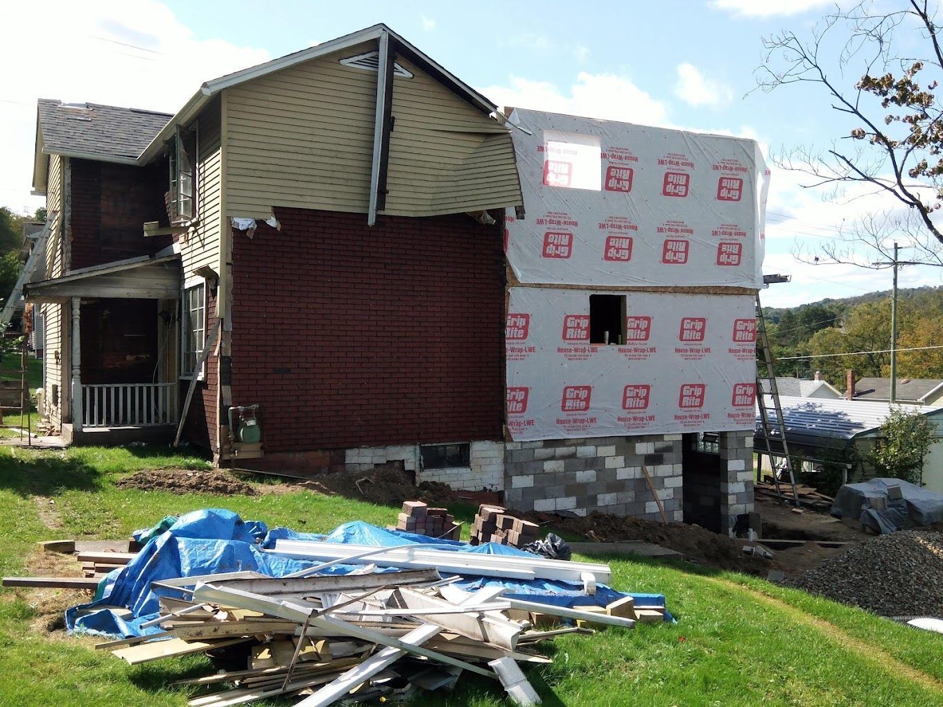 A house that is being remodeled with a lot of bricks