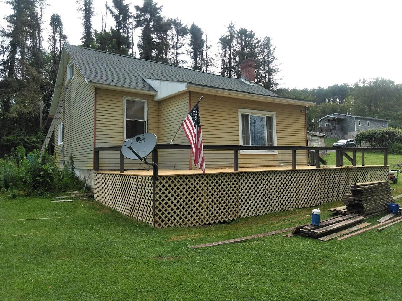 A small house with an american flag on the porch