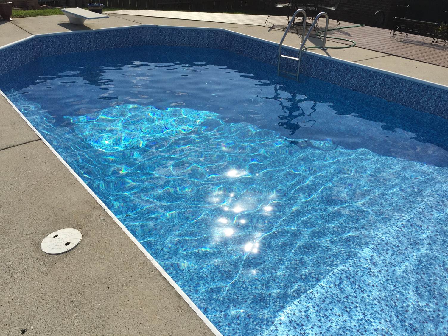 a large swimming pool with a ladder in it