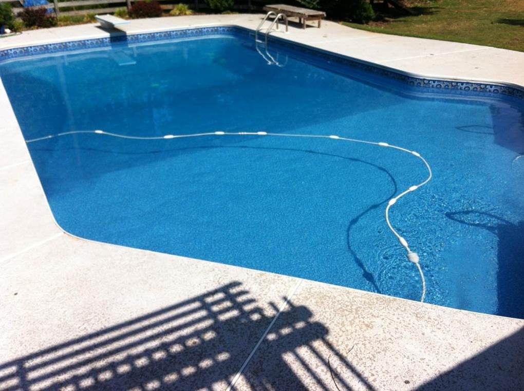 a large blue swimming pool with a ladder on the side