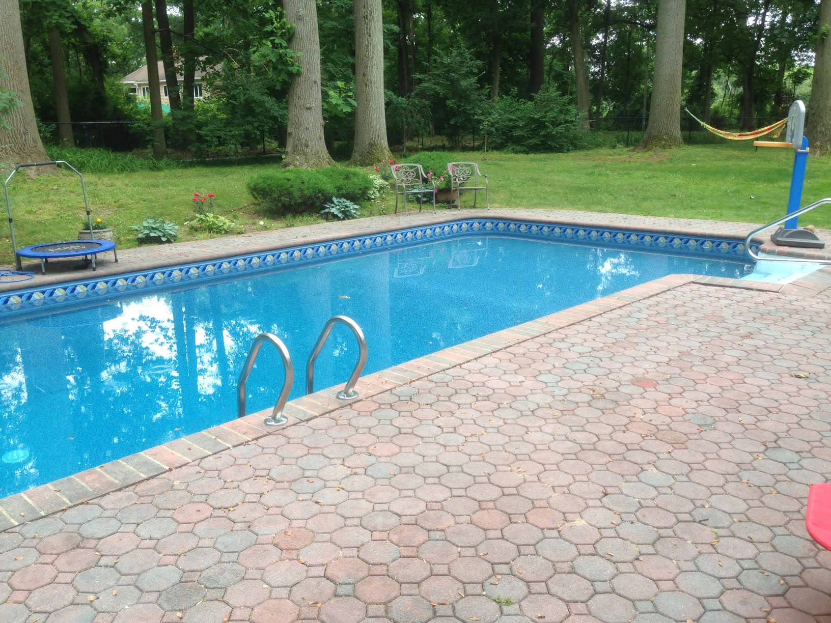 a large swimming pool with a backyard