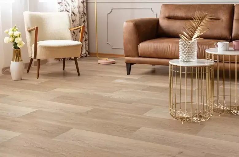 Living room with light wood flooring, a leather sofa, and a patterned accent chair.