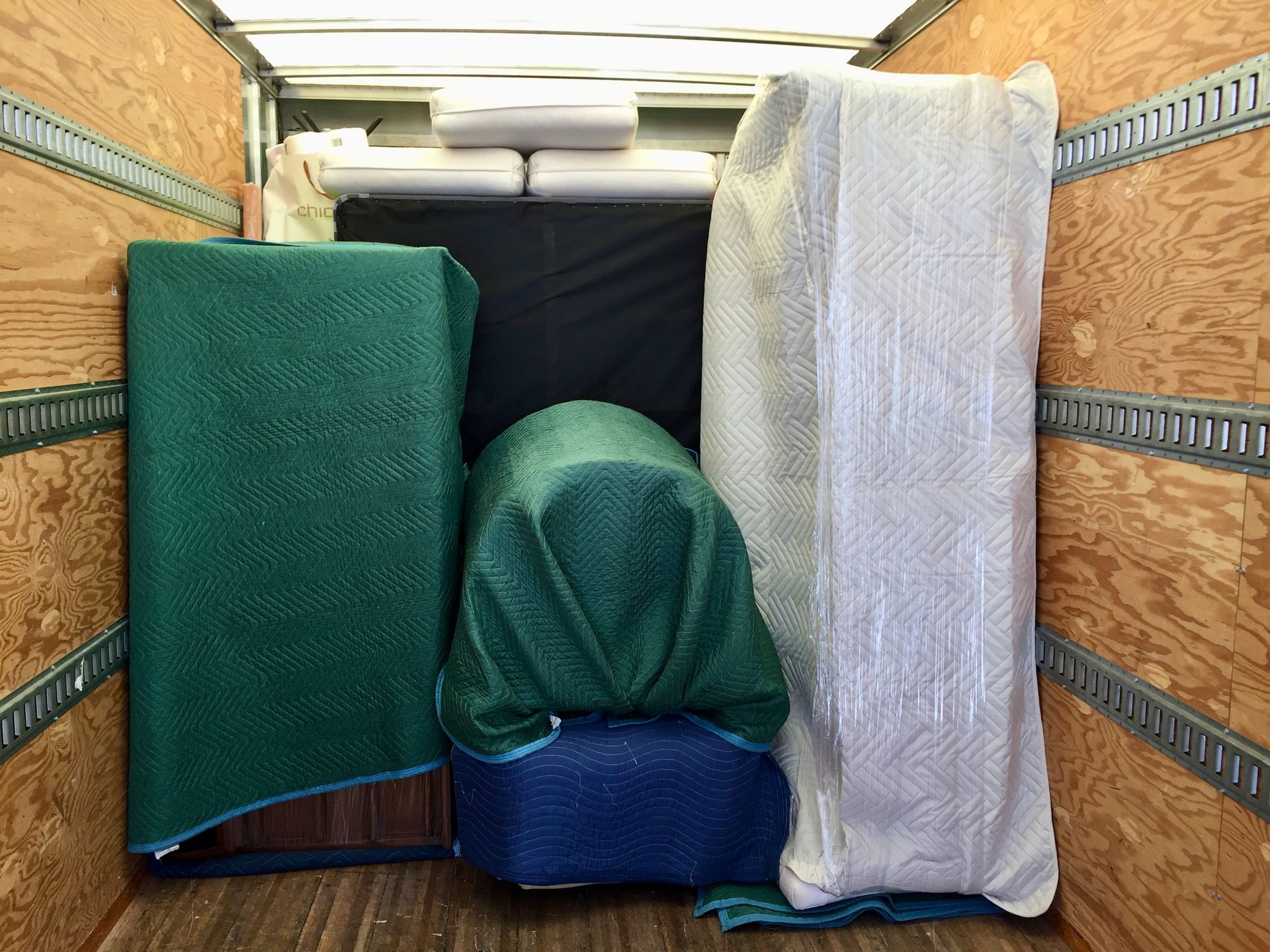 Couple watches movers load boxes into truck.