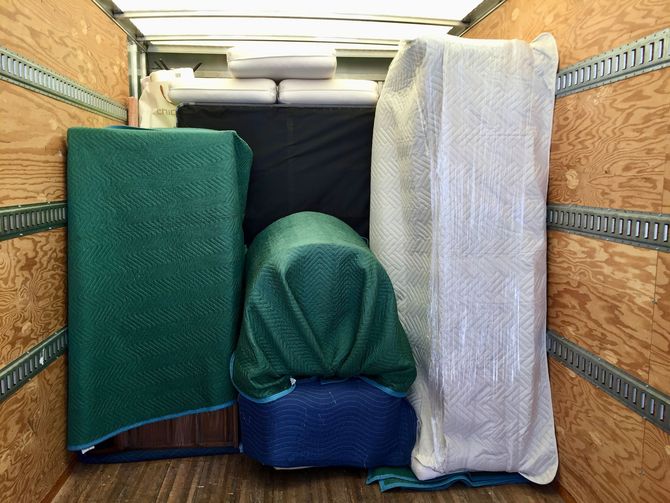 Couple watches movers load boxes into truck. Couple watches movers load boxes into truck.