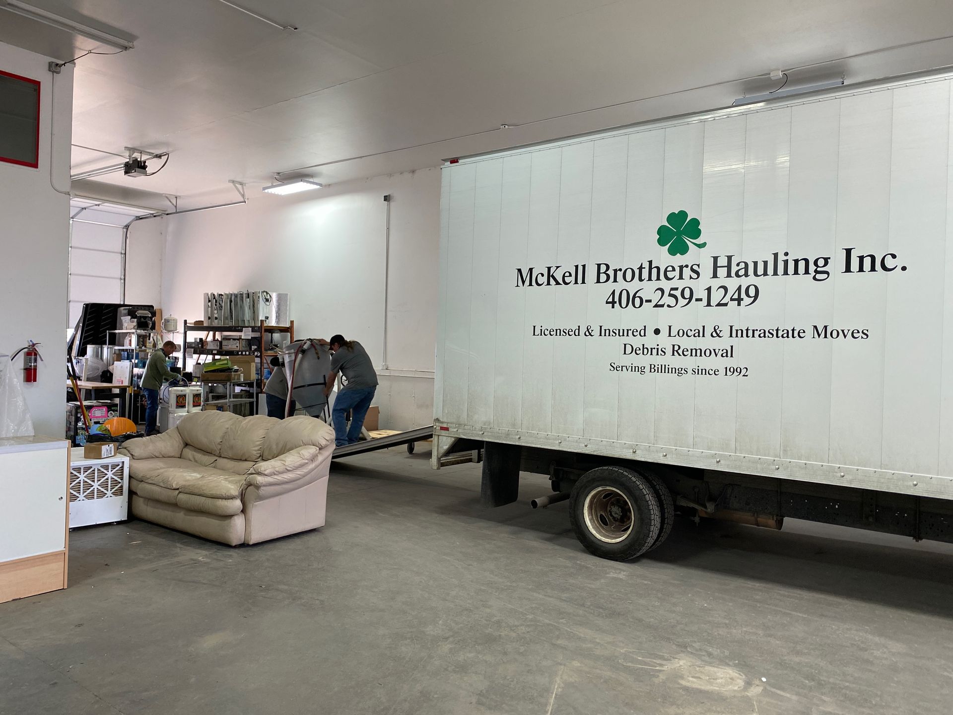 Empty office space with boxes and a computer monitor, ready for moving in.