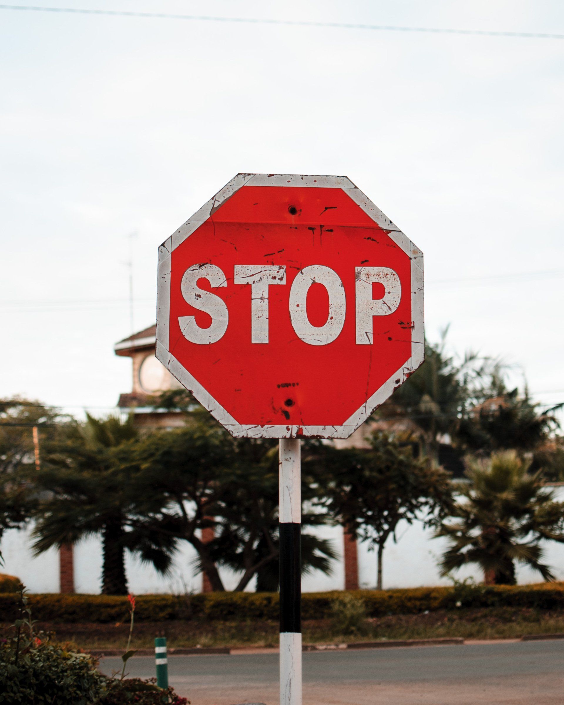 A stop sign is sitting on the side of the road
