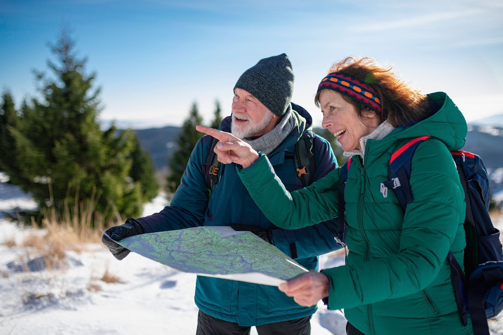 A man and a woman are sitting on a couch talking to a woman.