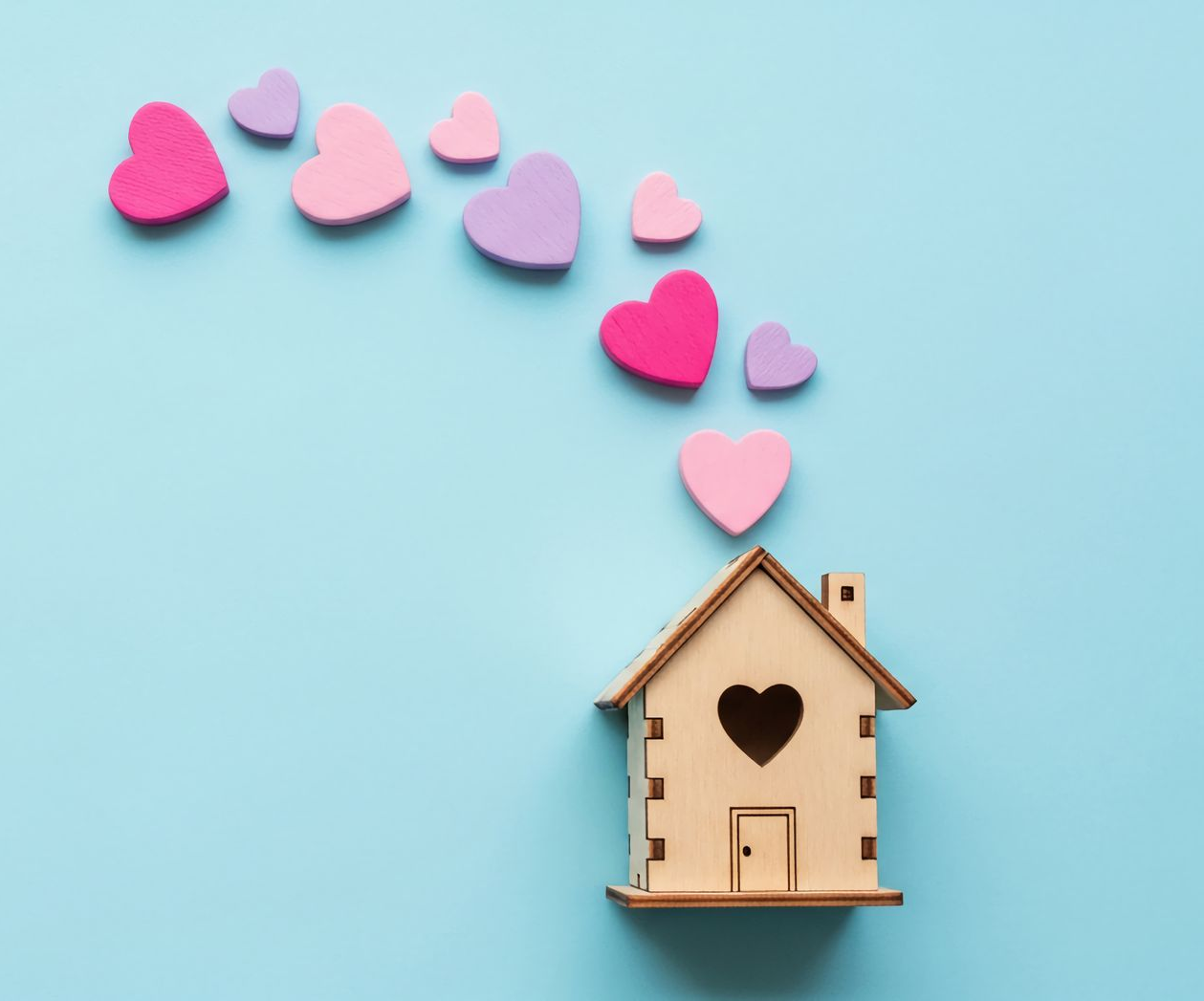 A man with a beard and glasses is sitting at a desk with his arms crossed.