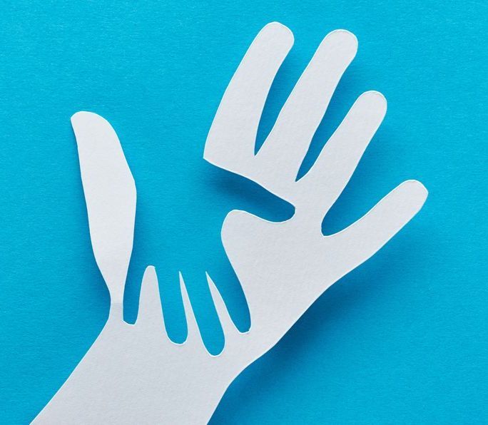Two white paper hands on a blue background