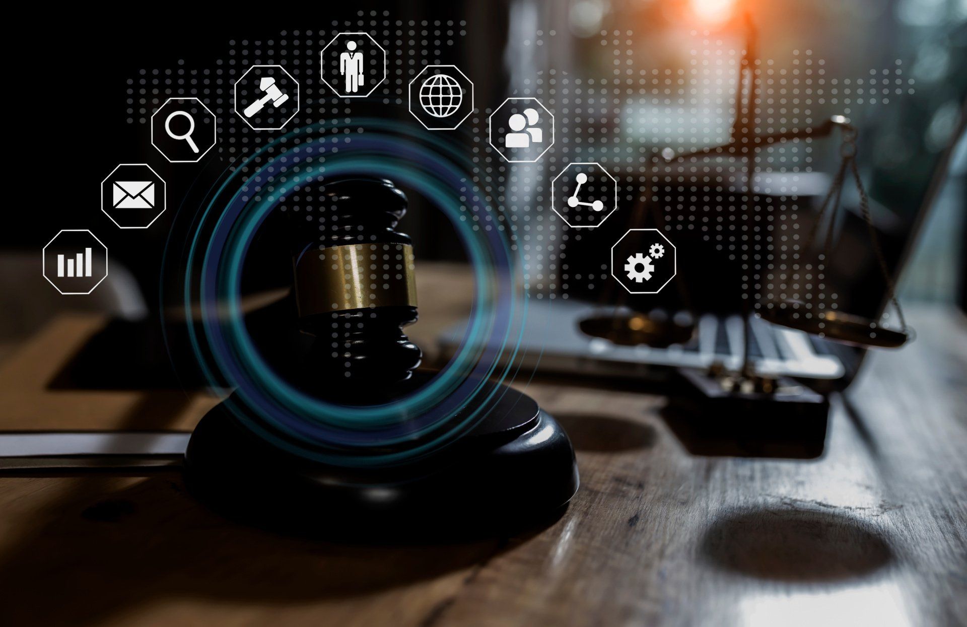 A judge 's gavel is sitting on a wooden table next to a laptop.