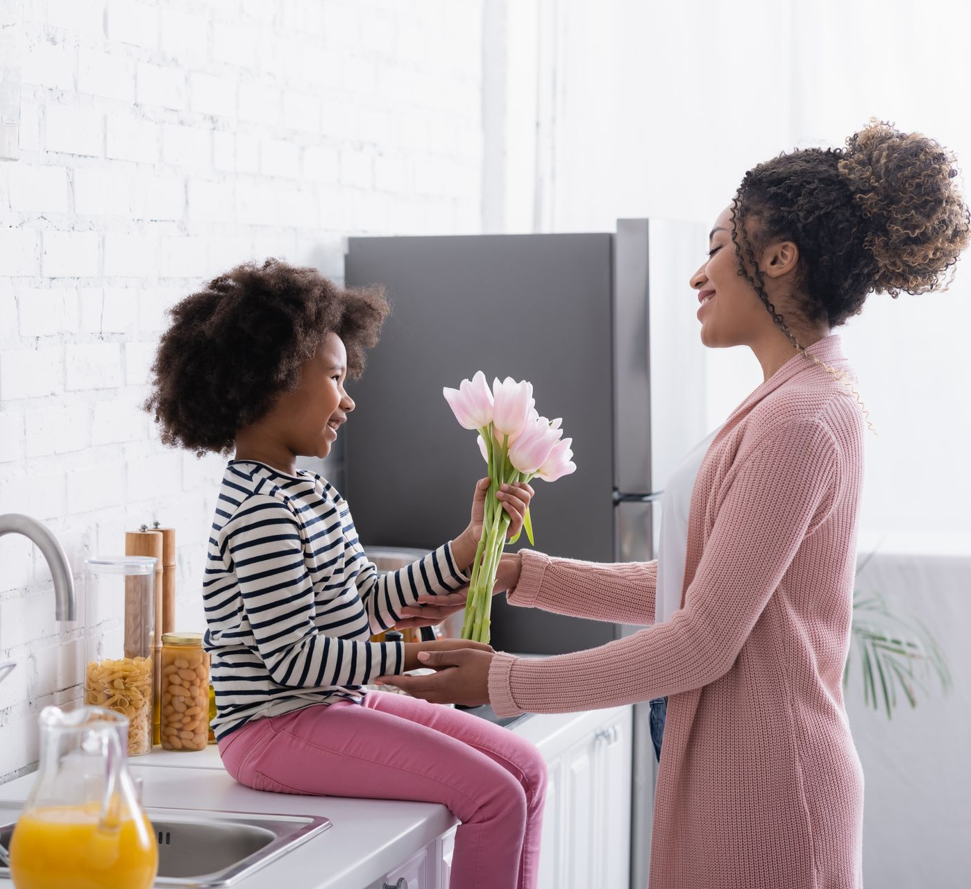 A woman is sitting at a table holding a wedding ring in her hands. Stock photo representing potential client of bob leonard law group. 