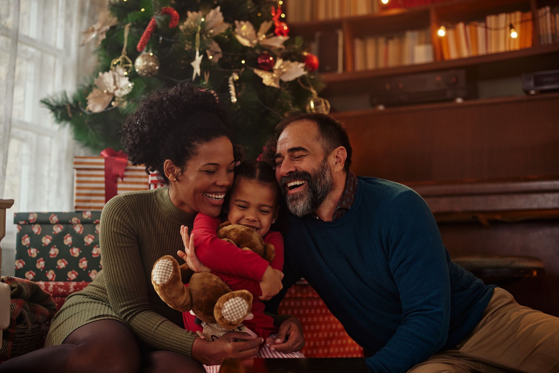 A man and a woman are standing on a bridge overlooking a lake.