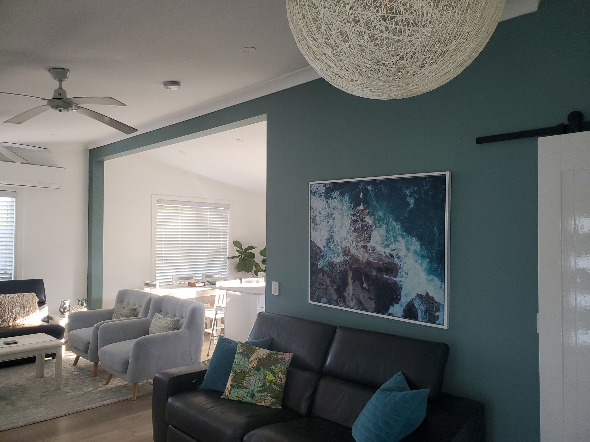 An Empty Room with a Ceiling Fan and Windows — JWP Painting & Property Services in Ettalong Beach, NSW