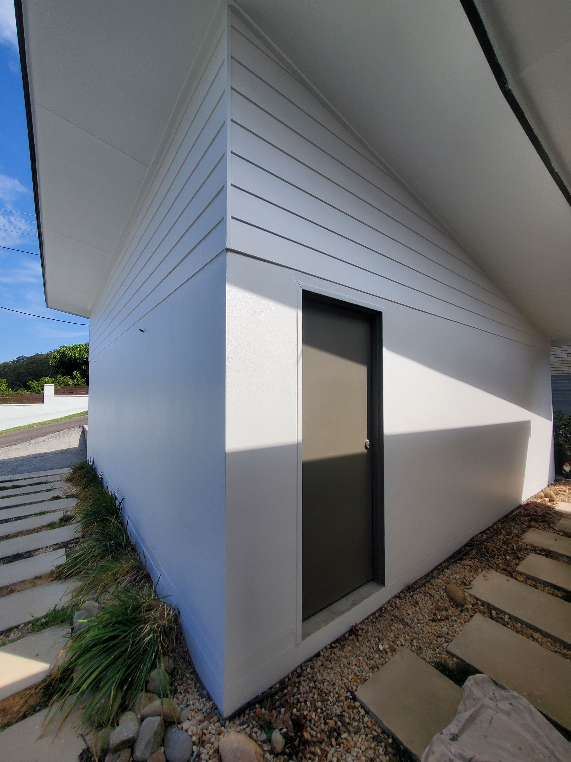 A white house with a door on the side of it — JWP Painting & Property Services in Ettalong Beach, NSW