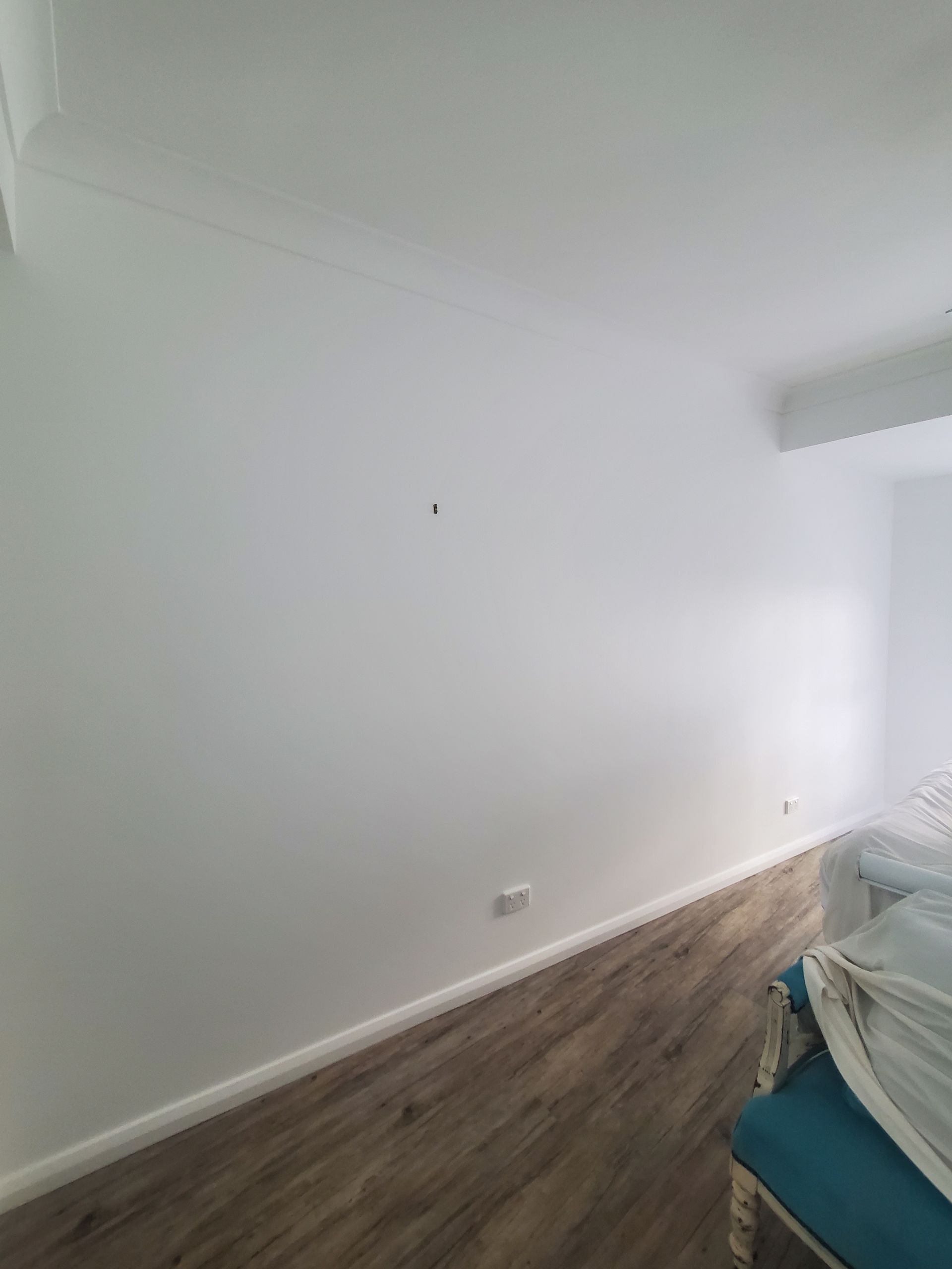 A bedroom with white walls and wooden floors — JWP Painting & Property Services in Ettalong Beach, NSW
