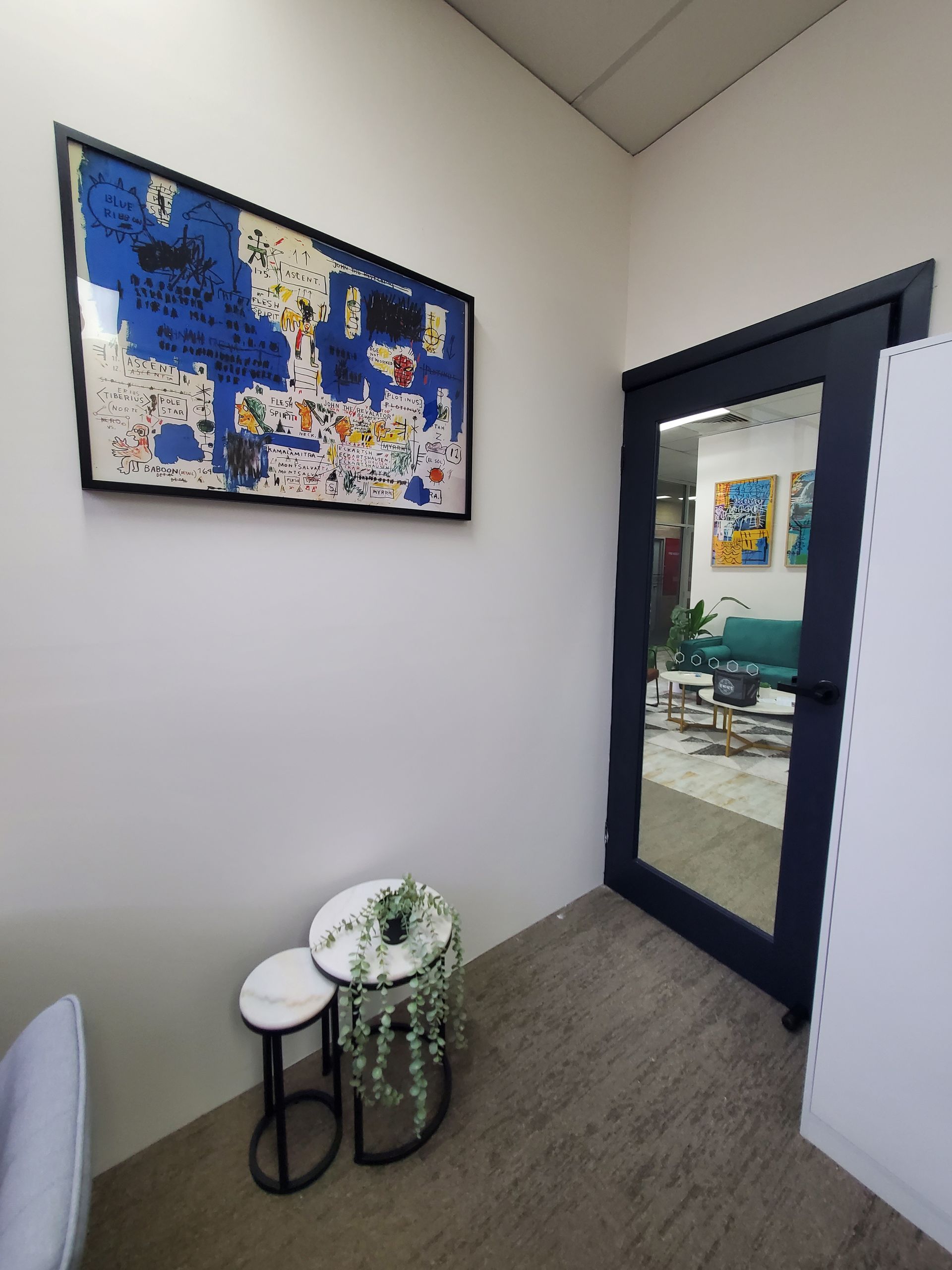 A room with two tables and a painting on the wall — JWP Painting & Property Services in Ettalong Beach, NSW