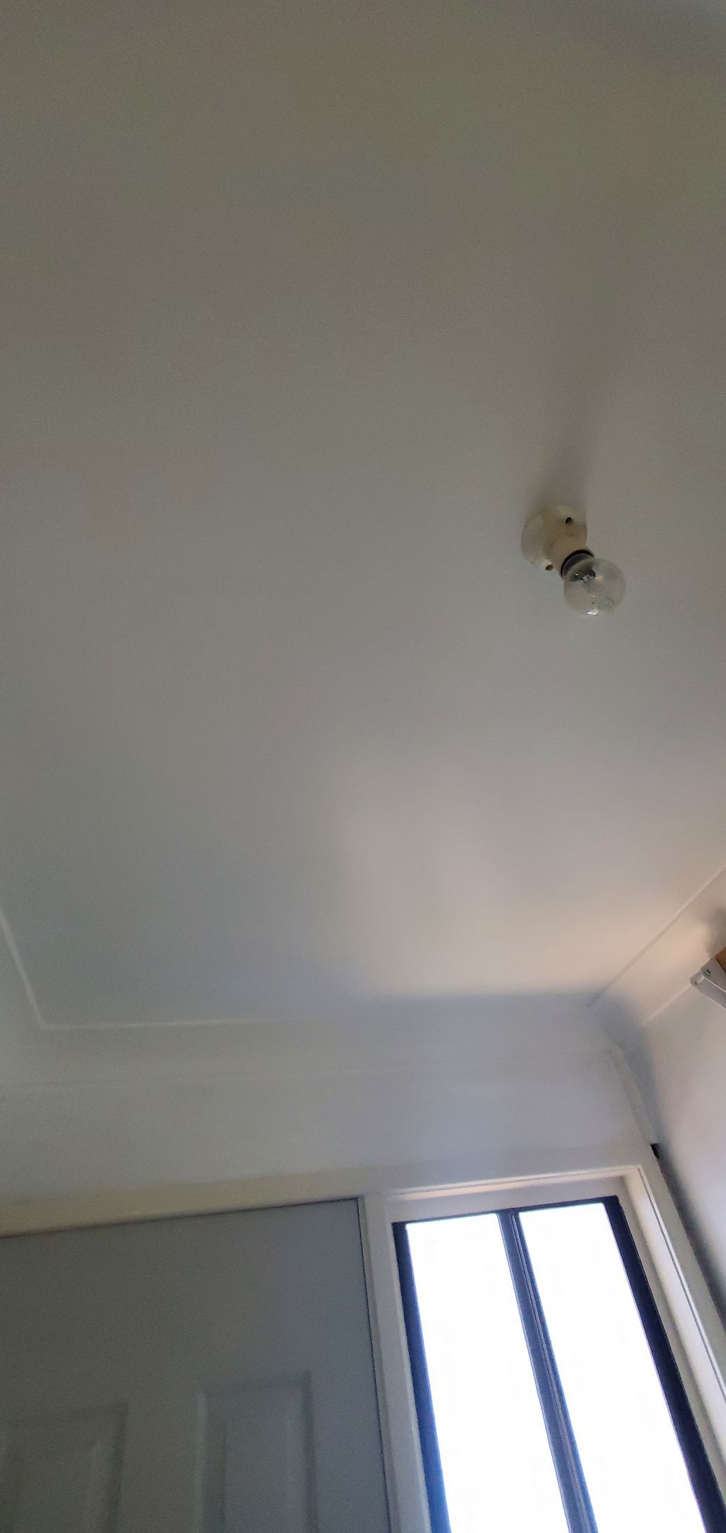 A room with a white ceiling and two windows — JWP Painting & Property Services in Ettalong Beach, NSW