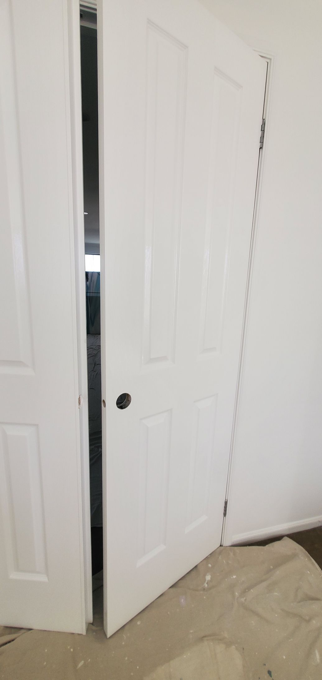 A pair of white doors are open in a room — JWP Painting & Property Services in Ettalong Beach, NSW