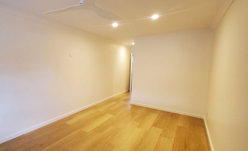 An Empty Room with Hardwood Floors and White Walls — JWP Painting & Property Services in Ettalong Beach, NSW