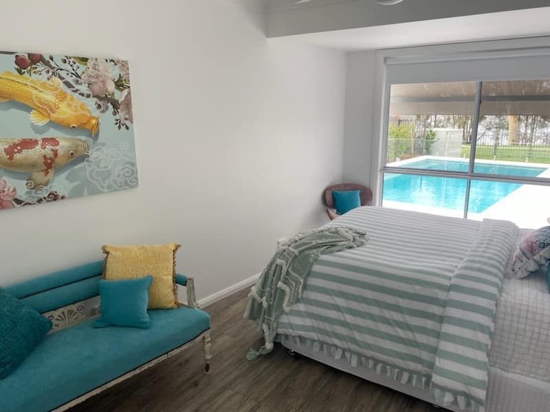 A Large Empty Room with a Brown Floor and White Walls — JWP Painting & Property Services in Ettalong Beach, NSW