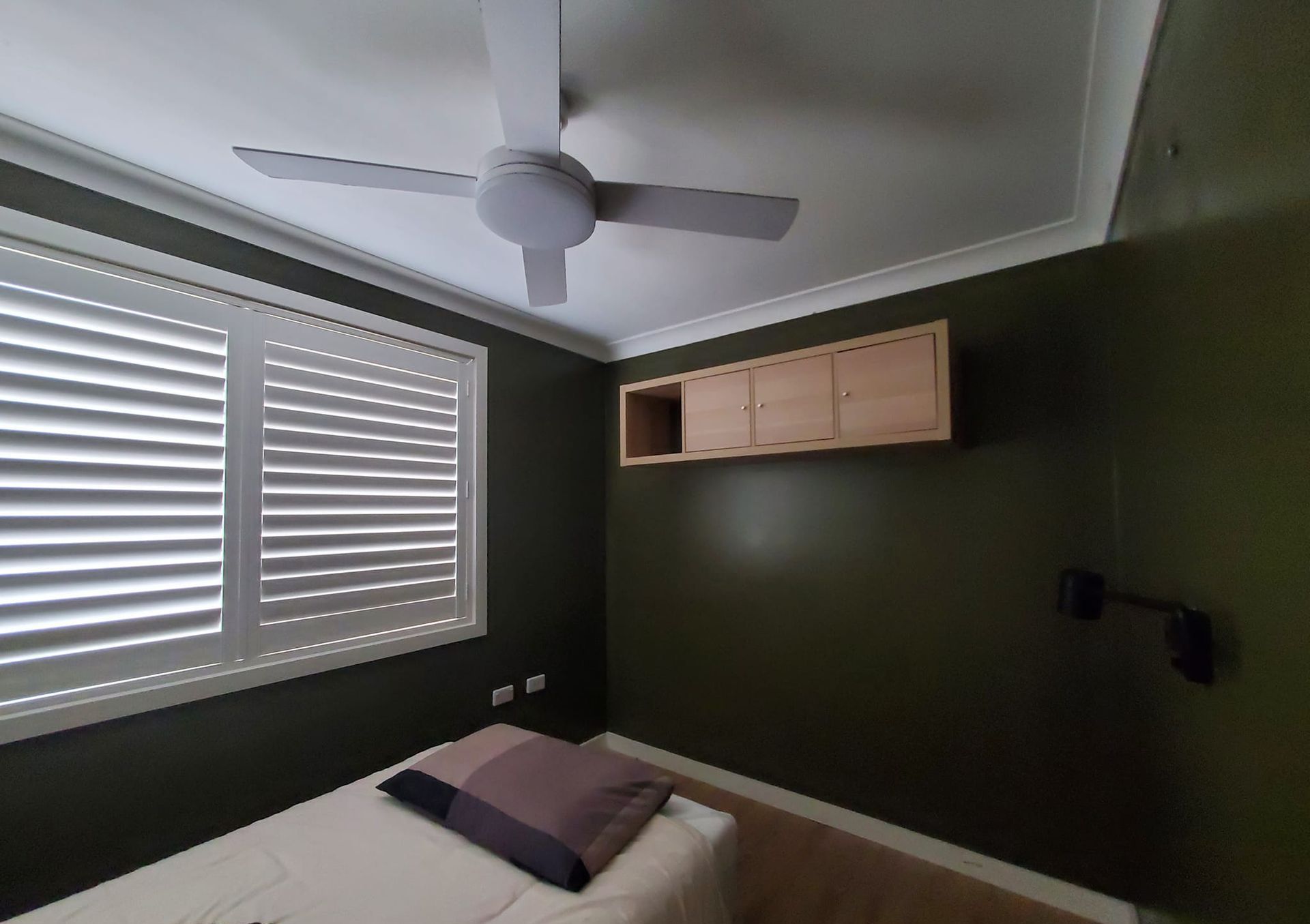 A bedroom with a bed and a ceiling fan — JWP Painting & Property Services in Ettalong Beach, NSW
