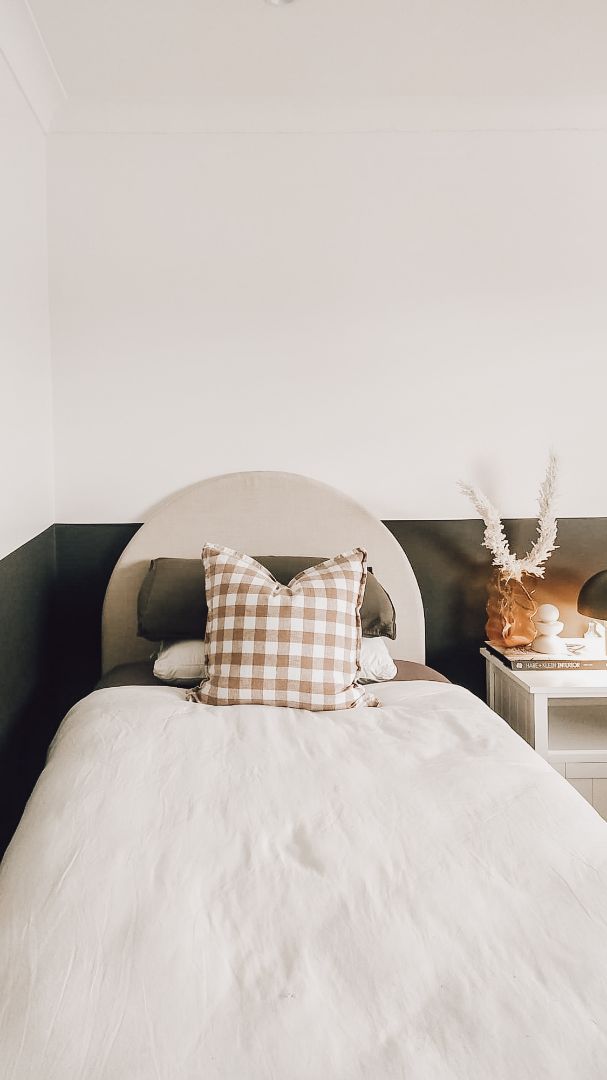 A bed with a pillow on top of it in a bedroom — JWP Painting & Property Services in Ettalong Beach, NSW