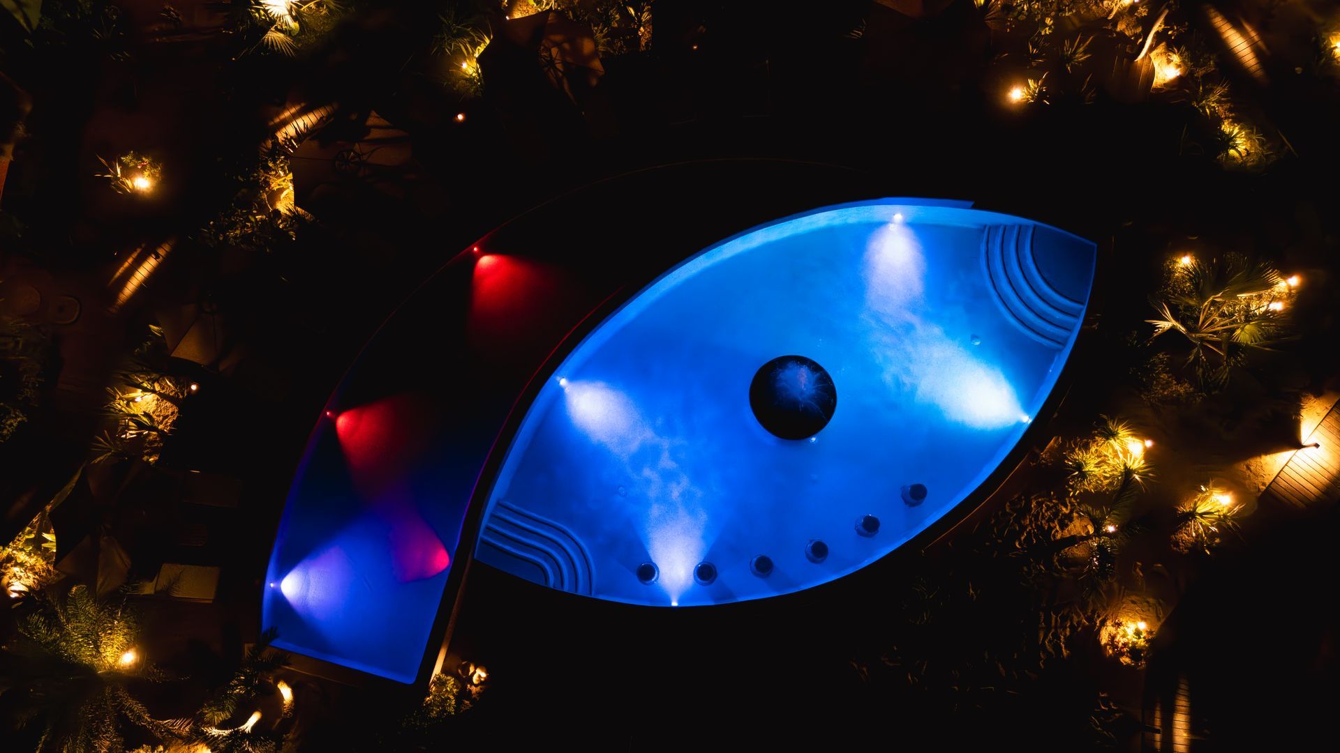 Una vista aérea de un árbol de Navidad con luces en la noche.
