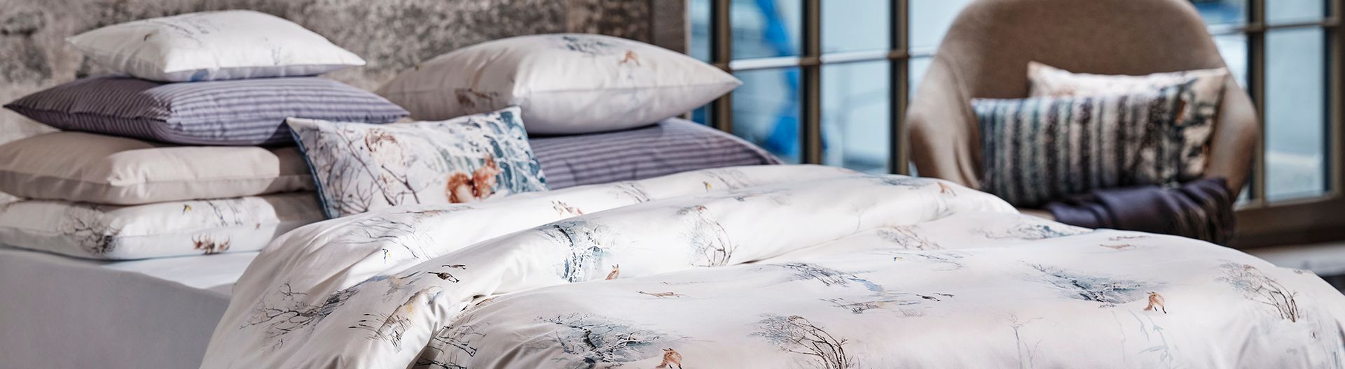 A bed with a blanket and pillows on it in a bedroom.