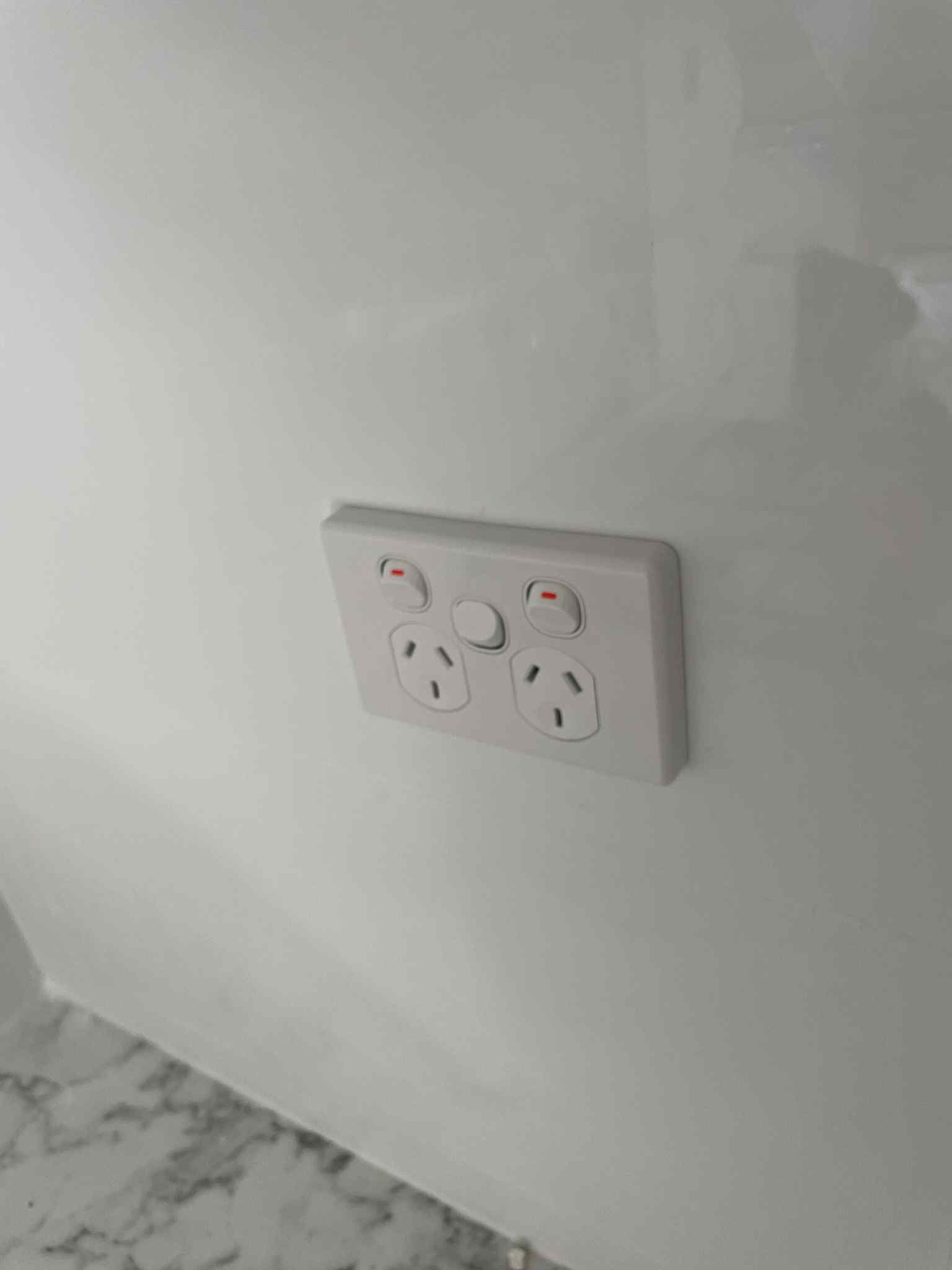 Ziesing Electrical technician securing wall switch faceplate