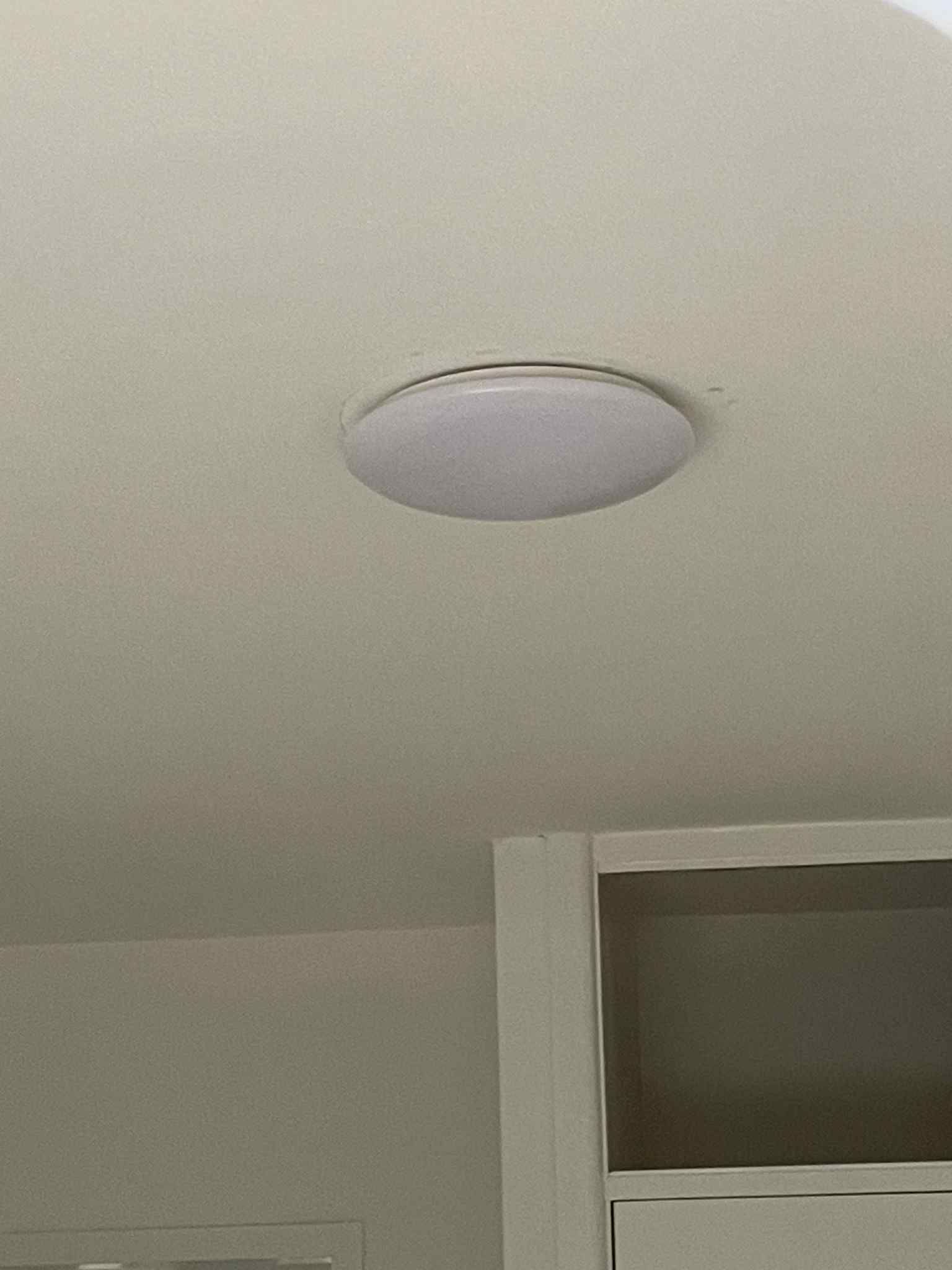 Licensed electrician wiring pendant light above Hampton kitchen bench — Ziesing Electrical