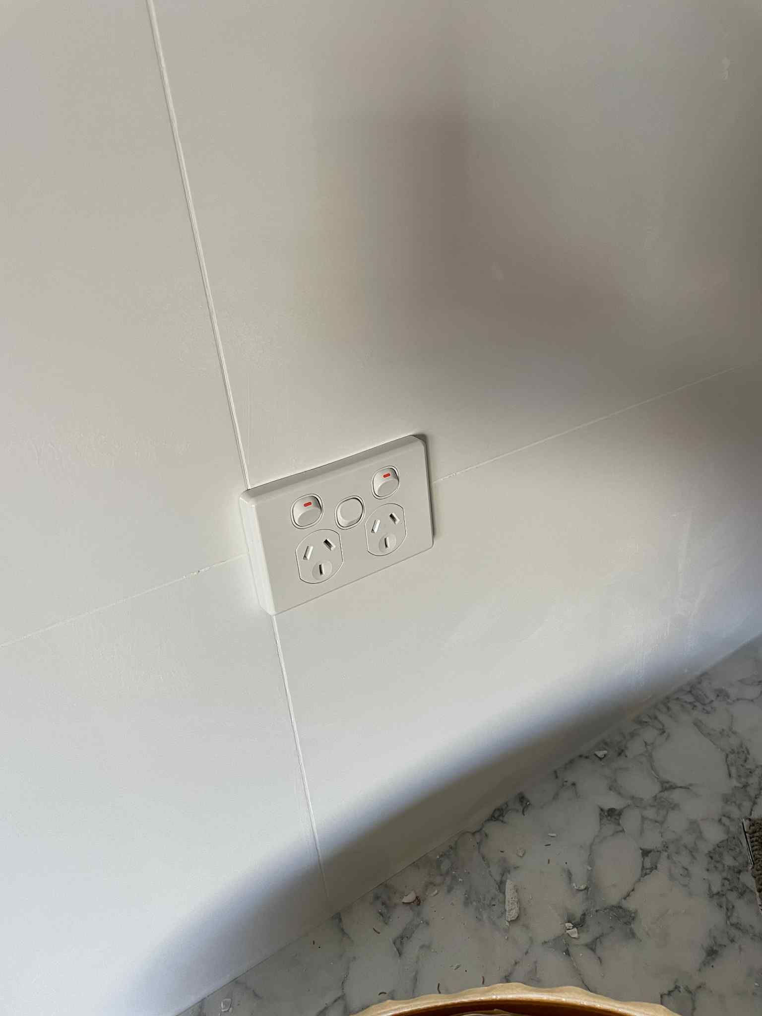 Technician testing power outlet voltage with multimeter