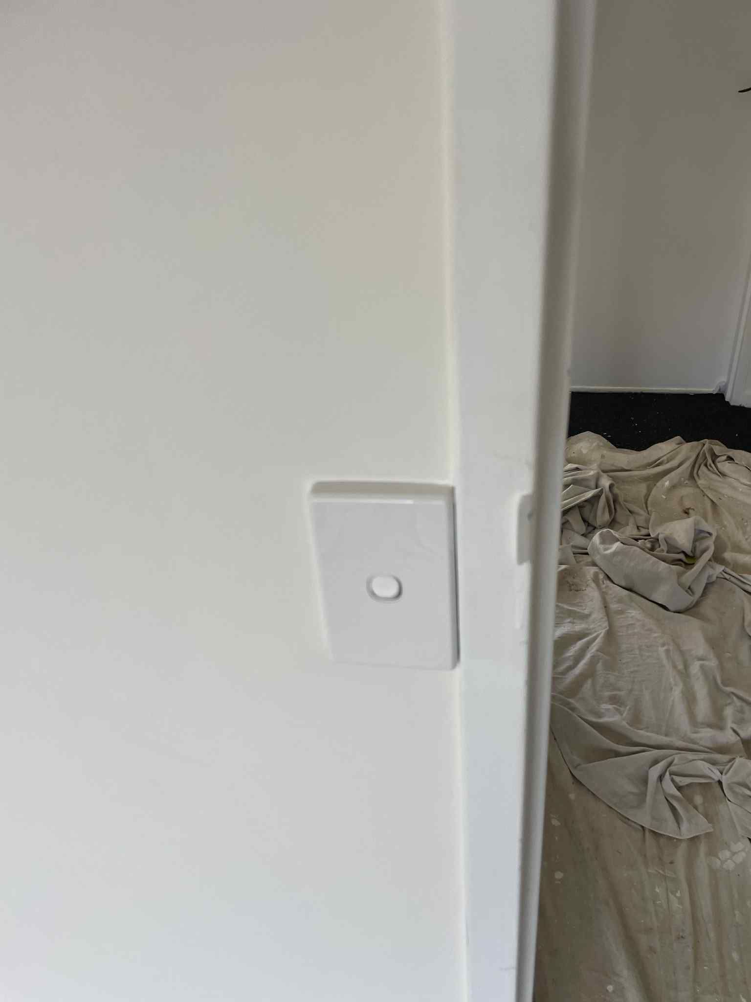 Ziesing Electrical technician testing consumer unit with multimeter