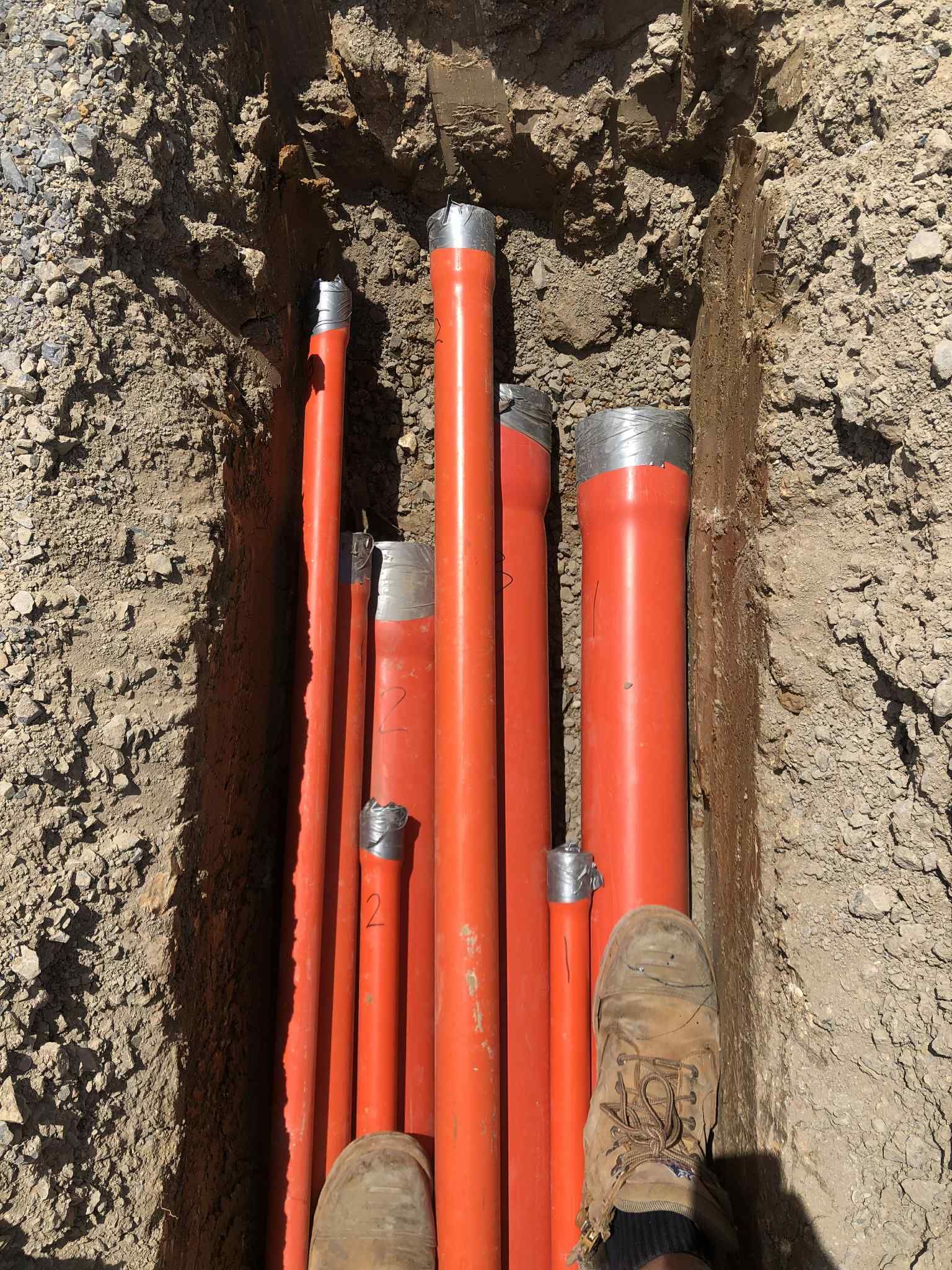 Ziesing electrical on the site Close-up bundle of orange underground conduits laid for electrical cabling in Bayside.