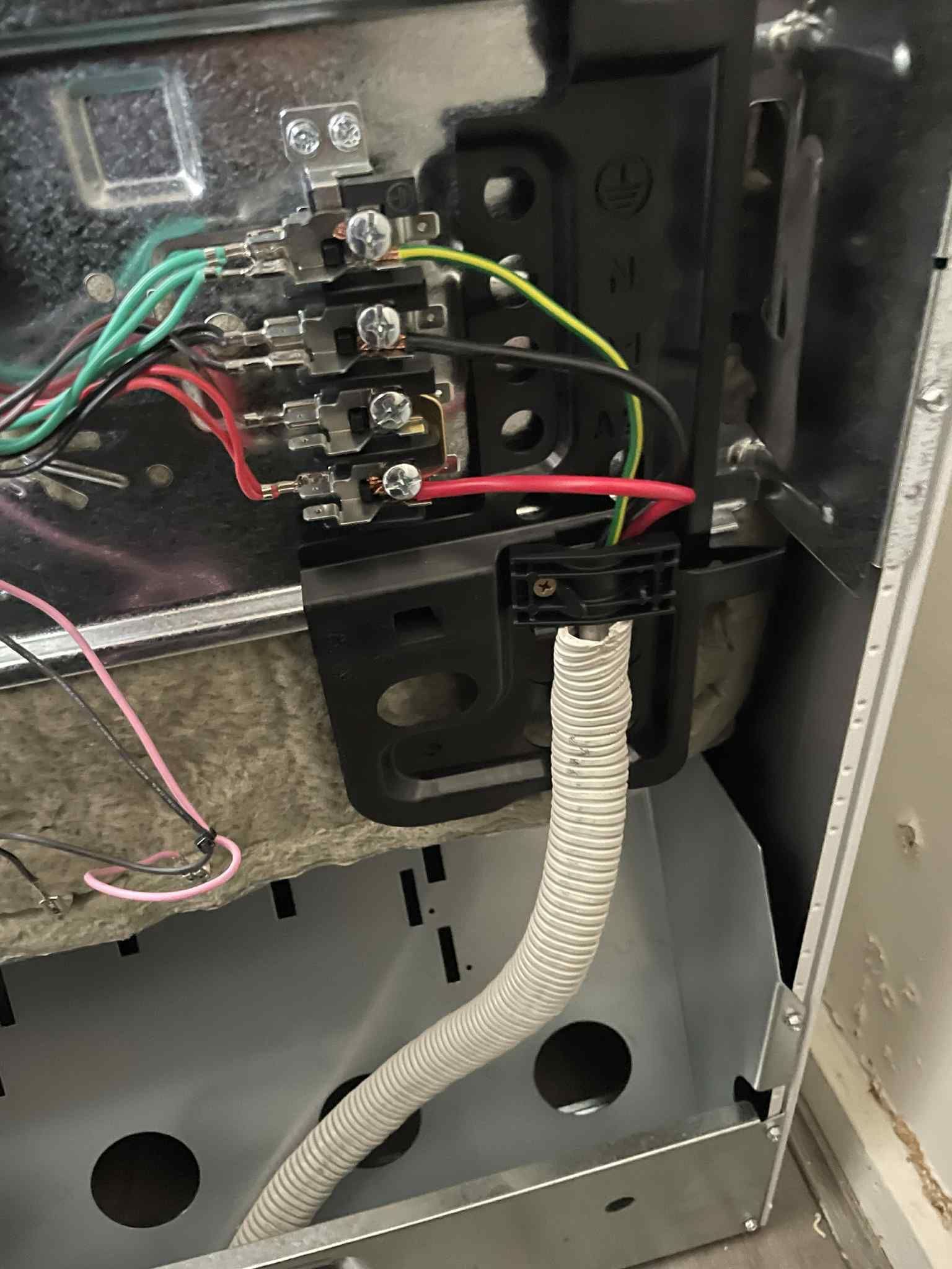 Bundled cables inside wall cavity ready for connection