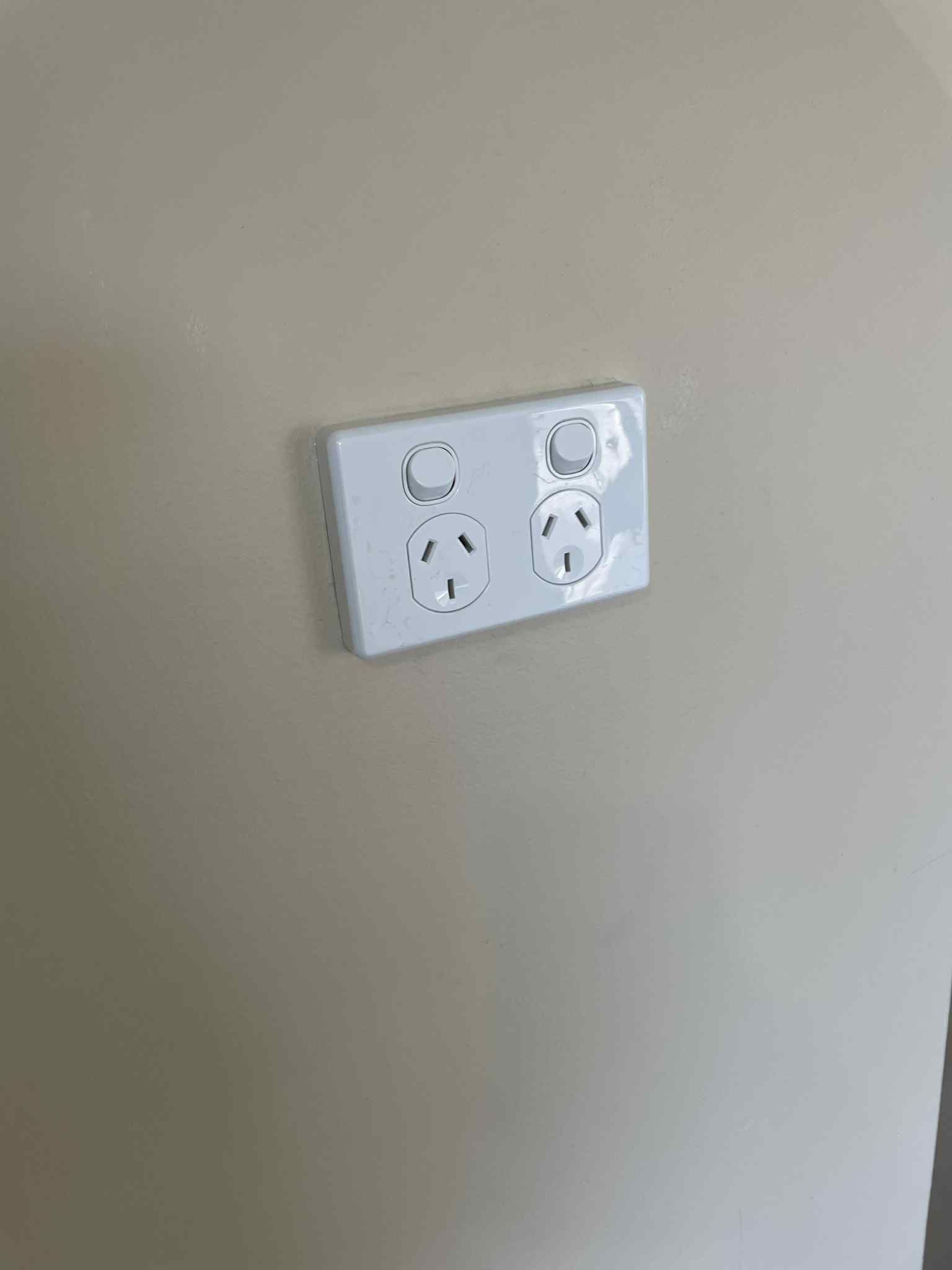 Light and fan switch plate installed near bathroom entry