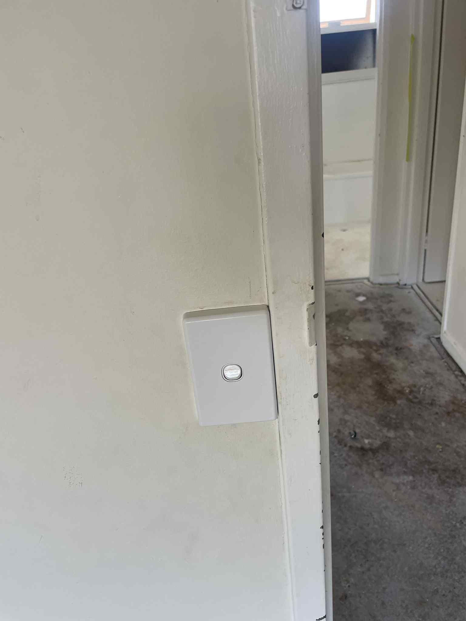 Electrician wiring new light switch during home renovation