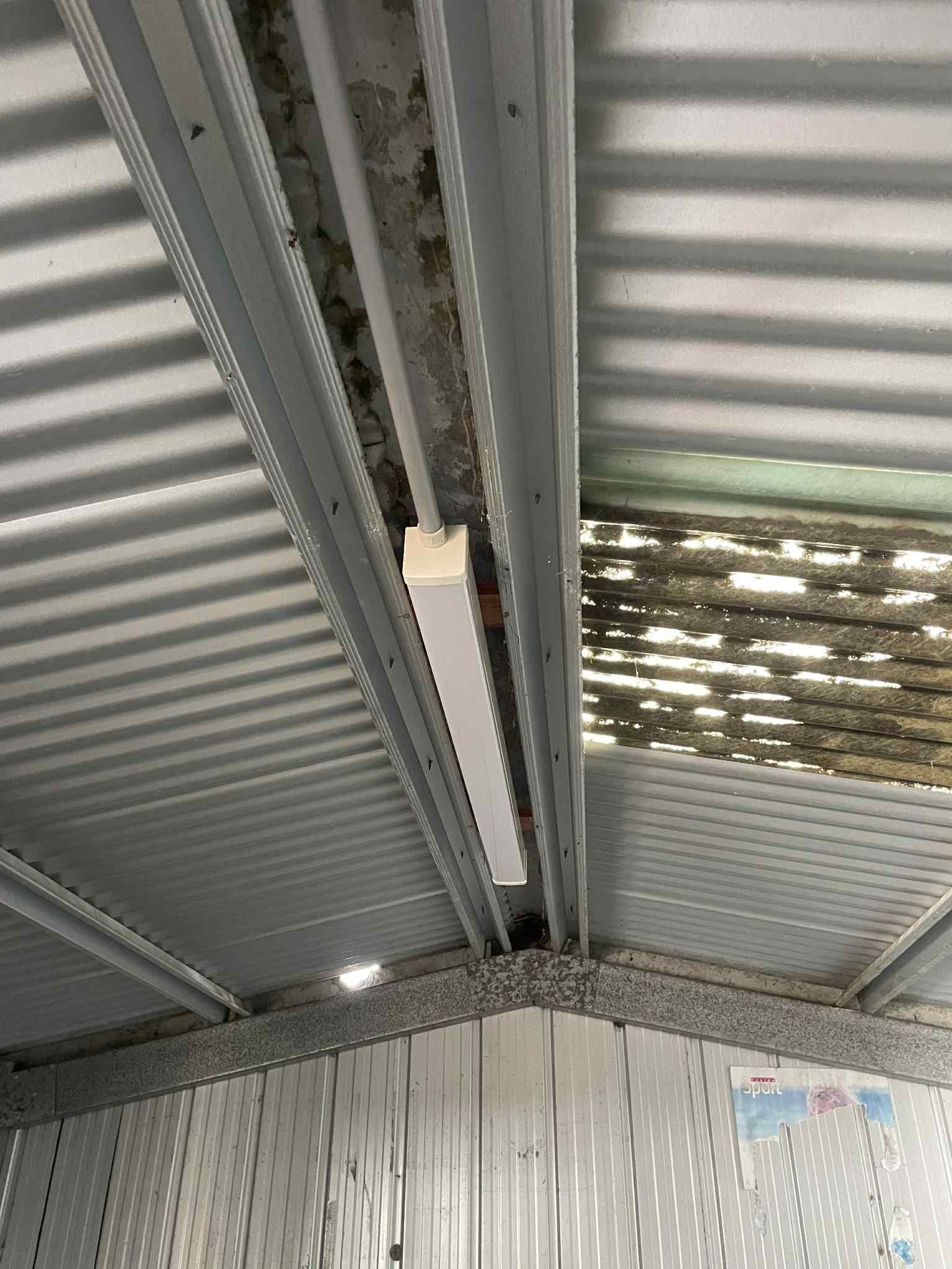 Electrician wiring EV charger in Hampton garage — Ziesing Electrical. Domestic electrical.